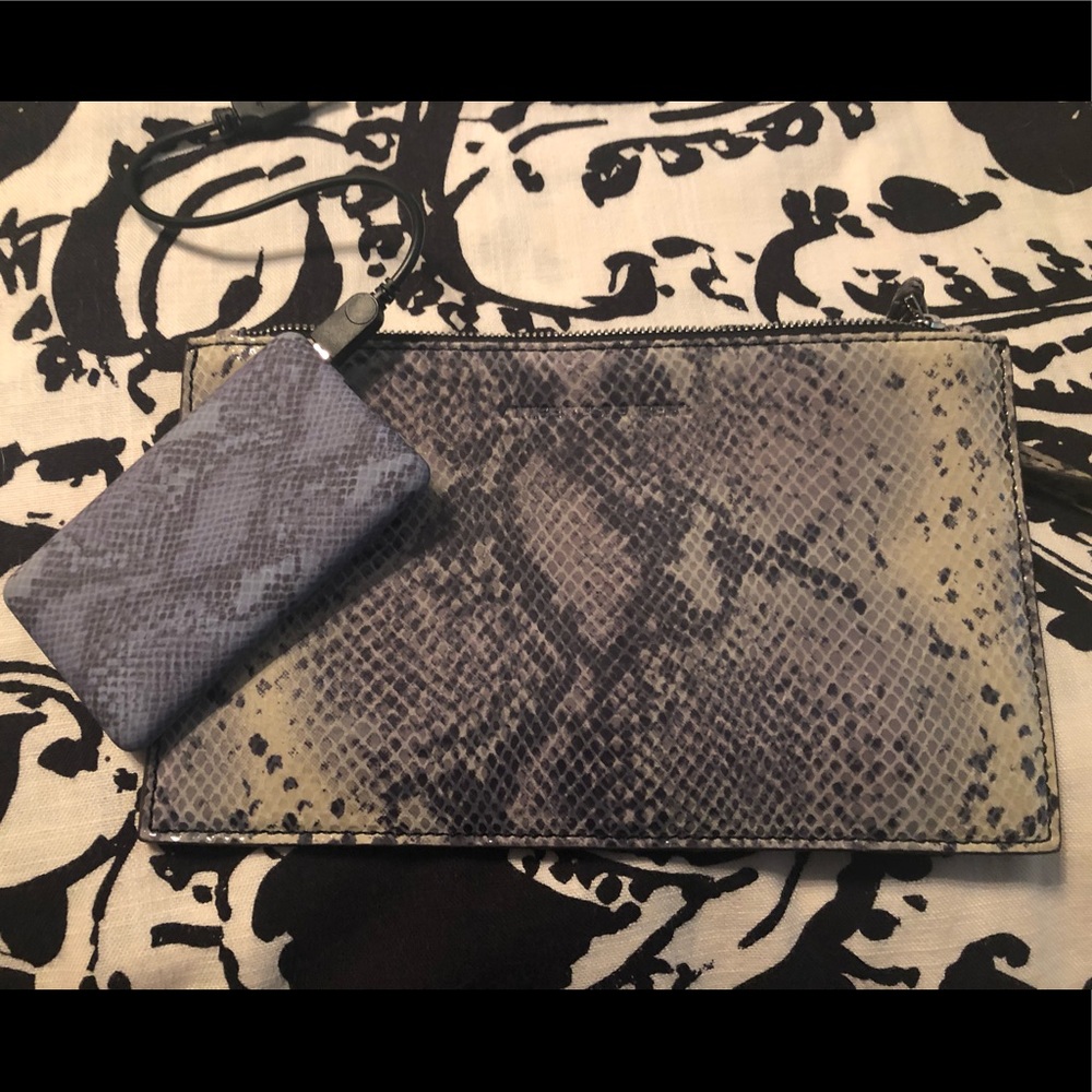 Clutch purse with portable cell phone charger